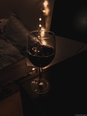 Glass of wine next to bed